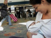breastfeeding-airport-getty Evelyn Dawkins (R) breast feeds her 4-month-old daughter Emilia Sofia in front of the Delta airlines ticket counter at the Fort Lauderdale airport in Florida 21 November 2006. Some 12 mothers and their babies congregated at the airport to highlight what they call 'a serious need for Federal Legislation within …