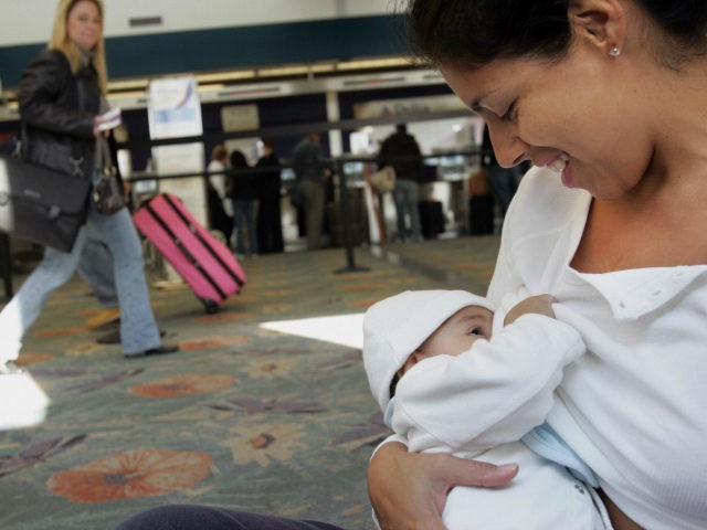 Evelyn Dawkins (R) breast feeds her 4-month-old daughter Emilia Sofia in front of the Delta airlines ticket counter at the Fort Lauderdale airport in Florida 21 November 2006. Some 12 mothers and their babies congregated at the airport to highlight what they call 'a serious need for Federal Legislation within …