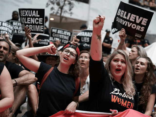 Activists shout slogans during a protest October 4, 2018 at the Hart Senate Office Building on Capitol Hill in Washington, DC. Activists are rallying in protest against Supreme Court associate justice nominee Brett Kavanaugh. (Photo by Alex Wong/Getty Images)