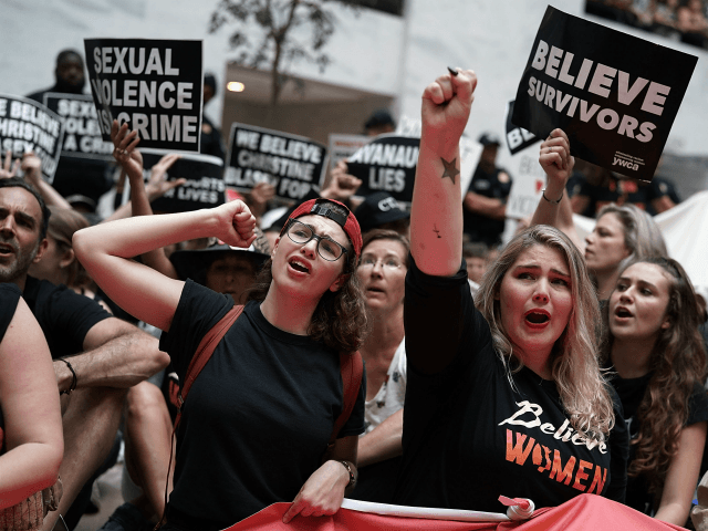 Activists shout slogans during a protest October 4, 2018 at the Hart Senate Office Buildin