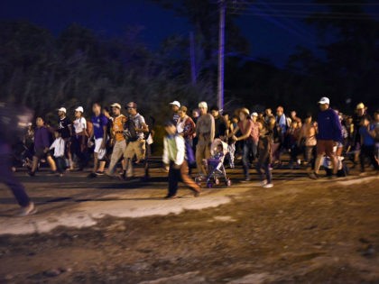 TOPSHOT - Honduran migrants taking part in a caravan heading to the US, walk in Huixtla, Chiapas state, Mexico, on October 24, 2018. - Thousands of mainly Honduran migrants heading to the United States, a caravan President Donald Trump has called an 'assault on our country', continued their march to …