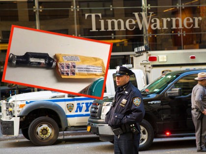 An officer keeps watch in front of the Time Warner Building, where NYPD personnel removed an explosive device Wednesday, Oct. 24, 2018, in New York. (AP Photo/Kevin Hagen)