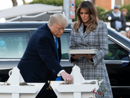 US President Donald Trump and First Lady Melania Trump place stones and flowers on a memorial as they pay their respects at the Tree of Life Synagogue following last weekend's shooting in Pittsburgh, Pennsylvania, October 30, 2018. - Scores of protesters took to the streets of Pittsburgh to denounce a …