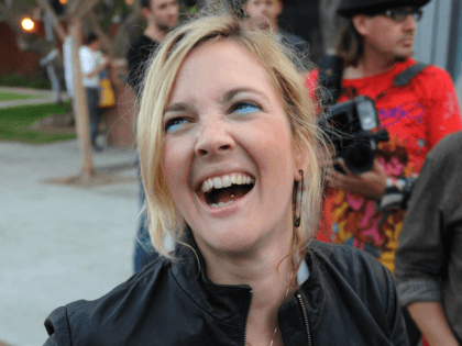 Actress Drew Barrymore laughs as she tries to pin on a 4 Equality badge during a Gay rights protest rally in Hollywood on May 26, 2009. California's Supreme Court upheld a referendum that outlawed gay marriage, but said 18,000 same-sex weddings carried out before the ban would remain valid. Gay …