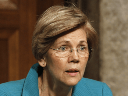 Sen. Elizabeth Warren, D-Mass., right, and Sen. Mark Warner, D-Va., share a laugh on Capit
