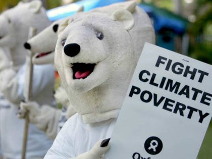 Oxfam activists wearing polar bear costumes stage a demonstration outside the venue of the