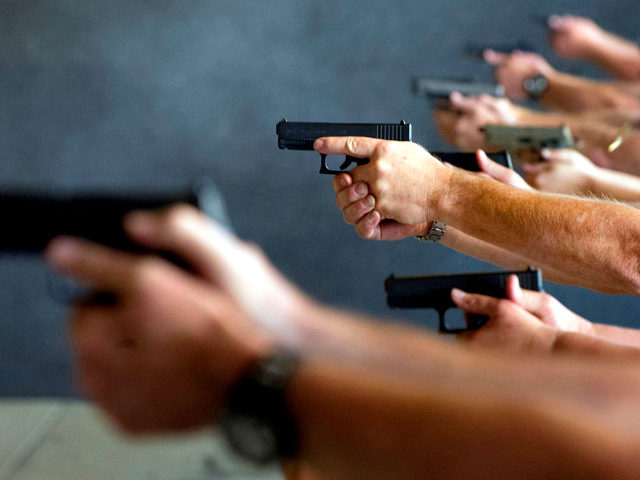 School teachers and administrators fire their guns during a three-day firearms course spon