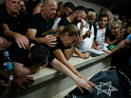 Relatives and friends mourn during the funeral of Kim Levengrond Yehezkel, aged 28, one of