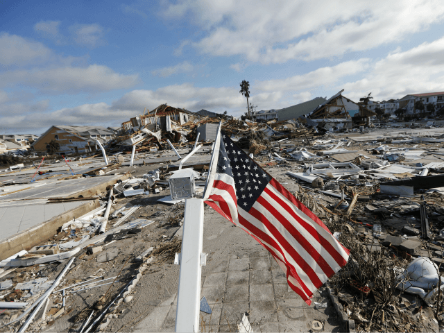 An American flag flies amidst destruction in the aftermath of Hurricane Michael in Mexico