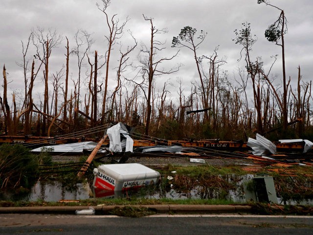 Shredded trees, derailed train cars and a sunken trailer are seen in the aftermath of Hurricane Michael in Panama City, Fla., Wednesday, Oct. 10, 2018. (AP Photo/Gerald Herbert)