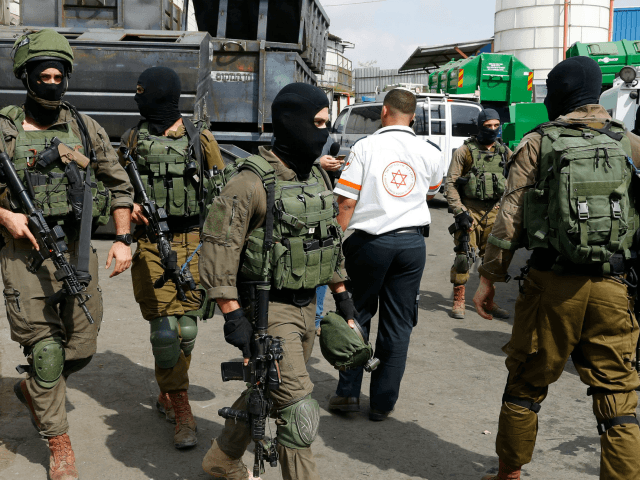 Israeli security forces gather at the site of a reported attack at the Barkan Industrial P