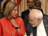 European Union High Representative for Foreign Affairs Federica Mogherini and Iranian Foreign Minister Mohammad Javad Zarif, from left, wait for the start of prior to a bilateral meeting as part of the closed-door nuclear talks with Iran at a hotel in Vienna, Austria, Friday, July 6, 2018. (AP Photo/Ronald Zak)