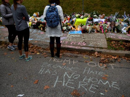 PITTSBURGH, PA - OCTOBER 29: People pause in front of at a memorial for victims of the mass shooting that killed 11 people and wounded 6 at the Tree Of Life Synagogue on October 29, 2018 in Pittsburgh, Pennsylvania. President Donald Trump will be visiting the synagogue Tuesday to pay …