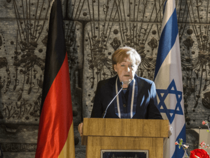 German Chancellor Angela Merkel (R) speaks as Israeli President Shimon Peres listens durin