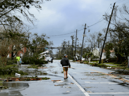 A man walks down the street after Hurricane Michael made landfall on October 10, 2018 in Panama City, Florida. - Michael slammed into the Florida coast on October 10 as the most powerful storm to hit the southern US state in more than a century as officials warned it could …
