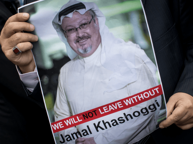 A man holds a poster of Saudi journalist Jamal Khashoggi during a protest organized by mem