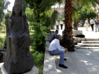 Syrians sit in the courtyard of the National Museum during a ceremony in the memory of Khaled al-Assaad, the late 82-year old retired chief archaeologist of the ancient Syrian city of Palmyra, on August 23, 2015 in the Syrian capital Damascus. The Islamic State (IS) group beheaded Al-Assaad, who refused …