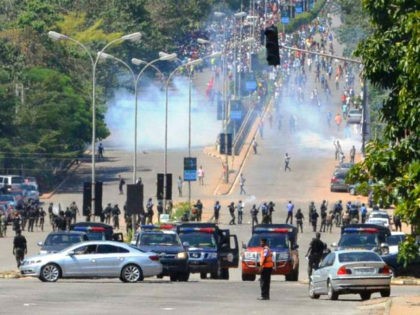 Nigerian police officers fire teargas at supporters of Islamic Movement of Nigeria (IMN) as they protest against the imprisonment of their leader Ibrahim Zakzaky, in Abuja, on October 30, 2018. - Nigerian police fired shots and tear gas at thousands of supporters of an imprisoned Shiite cleric in Abuja on …