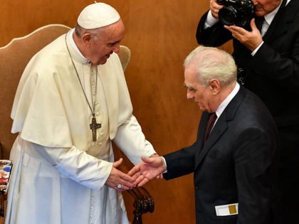 Pope Francis and US director Martin Scorsese (R) shake hands within an intergenerational dialogue themed 'The Wisdom of Time' with some young people and a group of elderly people at the Augustinianum Patristic Institute of higher education in Rome on October 23, 2018. (Photo by Alberto PIZZOLI / AFP) (Photo …