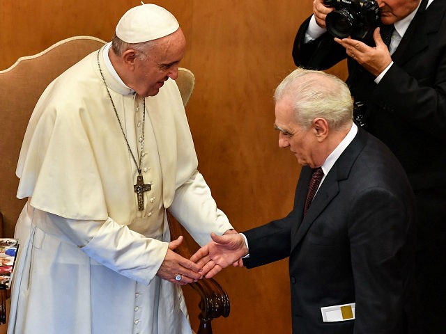 Pope Francis and US director Martin Scorsese (R) shake hands within an intergenerational d