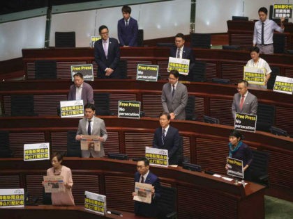 Pro-democracy lawmakers display placards "Press freedom persecution" to protest while Hong Kong Chief Executive Carrie Lam delivering her policy speech at the Legislative Council in Hong Kong Wednesday, Oct. 10, 2018. Hong Kong government has refused to renew the work visa of Victor Mallet, a senior editor of the Financial …