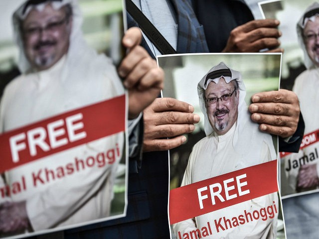 TOPSHOT - Protestors hold pictures of missing journalist Jamal Khashoggi during a demonstr