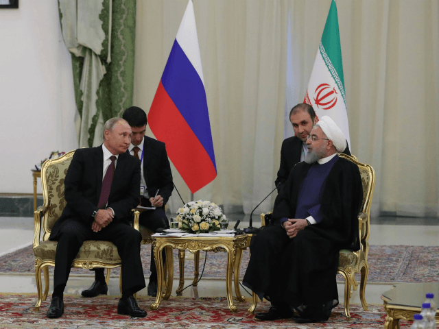 Russian President Vladimir Putin (L) and Iranian President Hassan Rouhani meet in Teheran on September 7, 2018. - The presidents of Iran, Russia and Turkey meet in Tehran for a summit set to decide the future of Idlib province amid fears of a humanitarian disaster in Syria's last major rebel …