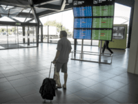 saudi arabian passenger A passengers walk through a hall past timetables displaying cancelled flights at the Lyon-Saint-Exupery airport on September 15, 2014. French flag carrier Air France said it would be forced to scrap half its flights on September 15 as pilots strike in protest at the company's plan to develop its low-cost …