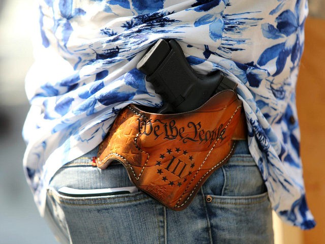 SEATTLE, WA - AUGUST 18: Detail of a holstered firearm of Matt Marshall, leader of the Washington 3%, attend the right-wing 'Liberty or Death - Rally Against Left Wing Violence' outside Seattle City Hall on August 18, 2018 in Seattle, Washington. Right wing groups including Patriot Prayer held a pro-gun …