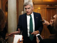 Sen. Bill Cassidy, R-La., speaks to reporters, Thursday, Oct. 19, 2017, on Capitol Hill in Washington. (AP Photo/Jacquelyn Martin)