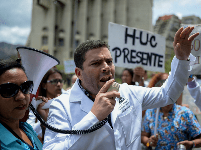 Health workers shout slogans demanding fair and higher wages during a protest for the lack of medicines, medical supplies and poor conditions in hospitals, in front of the headquarters of the Episcopal Conference in Caracas, on July 25, 2018. - The South American nation earns 96 percent of its revenue …