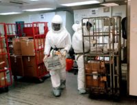 US Defense Department personnel, wearing protective suits, screen mail as it arrives at the Pentagon