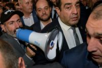 Armenian Prime Minister Nikol Pashinyan (L, pictured speaking to supporters at the protest), has been at loggerheads with the majority of lawmakers in parliament, who are allied to his predecessor