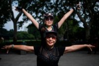Two women from a dancing troupe practise their moves in a public park in Shanghai -- part of a public dance craze that has become China's national pastime