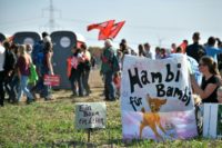 A banner reads "Hambi for Bambi" as thousands of demonstrators gather to celebrate the suspension of the planned razing of the forest in what they dubbed the region's "biggest-ever anti-coal rally"