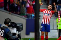 On top: Atletico Madrid's Angel Correa celebrates scoring the only goal