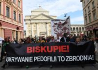 Protesters in Warsaw carry a banner reading "Bishop, protecting paedophiles is a crime" and a map of Polish places with documented child sex abuse cases involving church officials