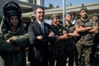 Jair Bolsonaro, a former army captain and now the front-runner in Brazil's presidential elections that have gone to a second round, poses for pictures with members of the armed forces during a military event in Sao Paulo, Brazil