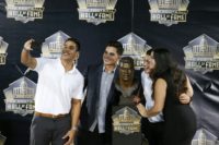 Junior Seau's children take a selfie in front of the late NFL player's bust during the Pro Football Hall of Fame induction ceremony in 2015