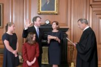Chief Justice John G. Roberts, Jr. (R) administers the Constitutional Oath to Judge Brett M. Kavanaugh at the Supreme Court on October 6, 2018