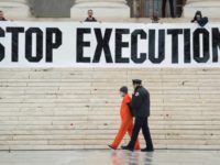 Police remove a man named Randy Gardner who is wearing his executed brother's prison jumpsuit during a protest against the death penalty outside the US Supreme Court in Washington, in January 2017 Washington State ends 'arbitrary, racially biased' death penalty