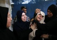 The mother (C) of Palestinian Ahmed al-Taweel, shot dead by Israeli troops during protests along the Gaza-Israel border, mourns at his funeral in central Gaza's Nuseirat camp on October 13, 2018