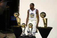 Golden State Warriors star Kevin Durant poses with two Larry O'Brien NBA Championship trophies Trophies and two NBA Finals MVP trophies