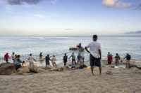 Fishermen and tourists gather on a beach near the town of Le Carbet of the French Caribbean island of Martinique in July, 2014