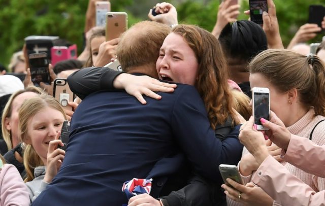Fans face rain to greet Harry and Meghan on Down Under tour