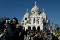 Tourists throng the steps outside the Sacre Coeur basilica in Paris' iconic Montmartre district, an area at risk of being swamped by mass tourism
