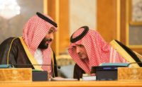 This handout picture provided by the Saudi Royal Palace on July 10, 2017, shows Saudi Crown Prince Mohammed bin Salman speaking with Interior Minister Prince Abdelaziz bin Saud bin Nayef during a cabinet meeting chaired by the king in Mecca