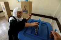 An Iraqi Kurdish woman casts her ballot for the parliamentary election at a polling station in Arbil, the capital of the Kurdish autonomous region, on September 30, 2018