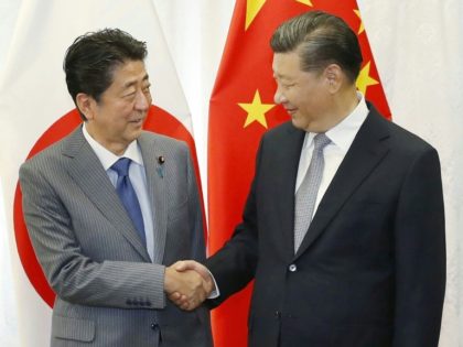 Japan's Abe makes rare China visit as relations thaw