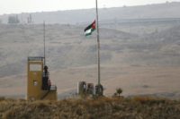 A picture taken from the Israeli side of the border fence in Naharayim also known as Baqura, shows a Jordanian national flag flying at a military outpost on October 22, 2018